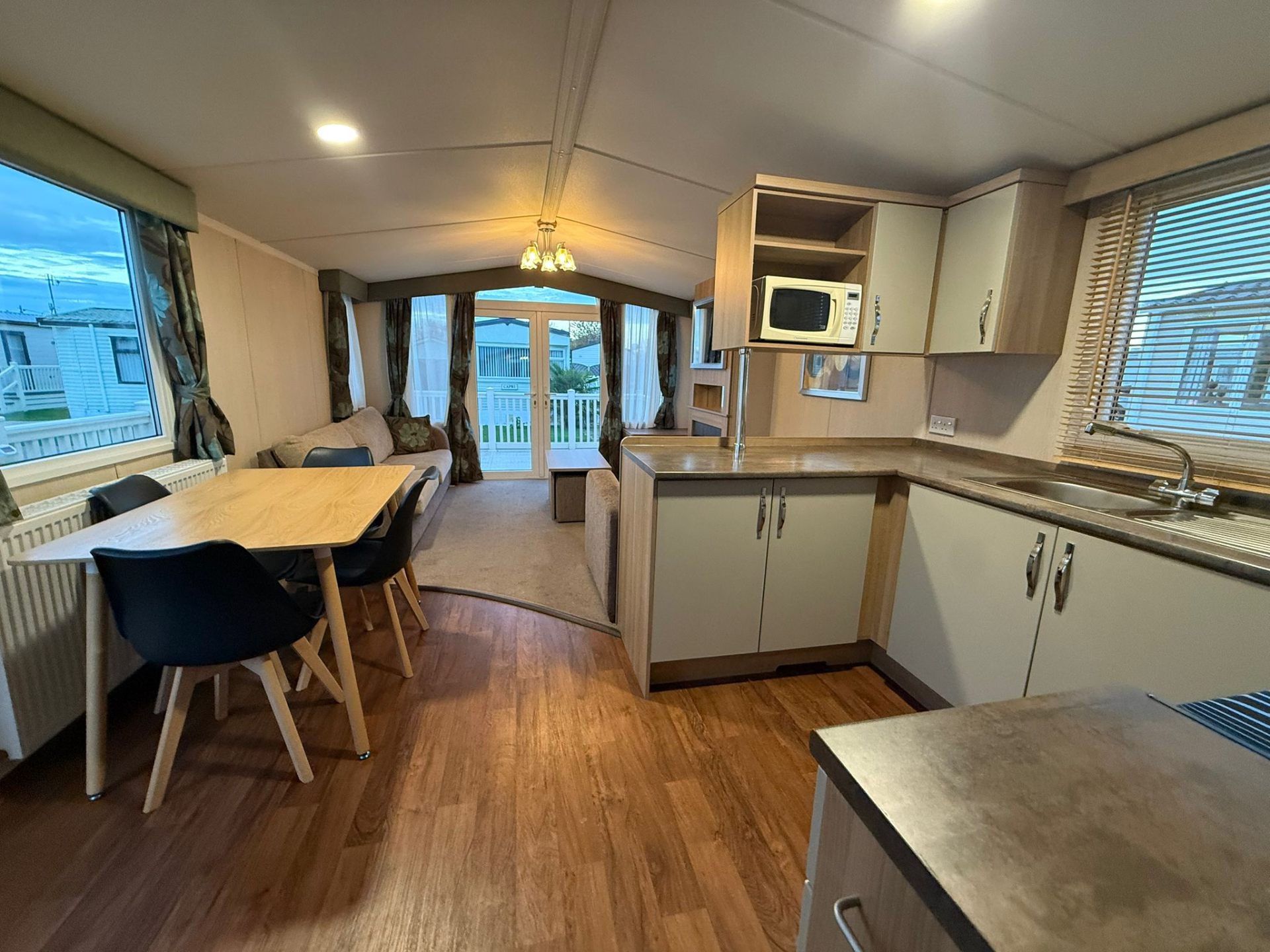 Open plan lounge, dining area and kitchen inside Buckingham Retreat